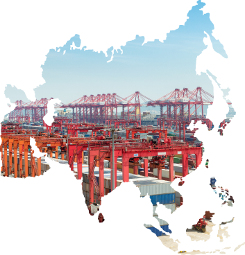 Aerial view of a busy container port with rows of ship-to-shore cranes loading cargo